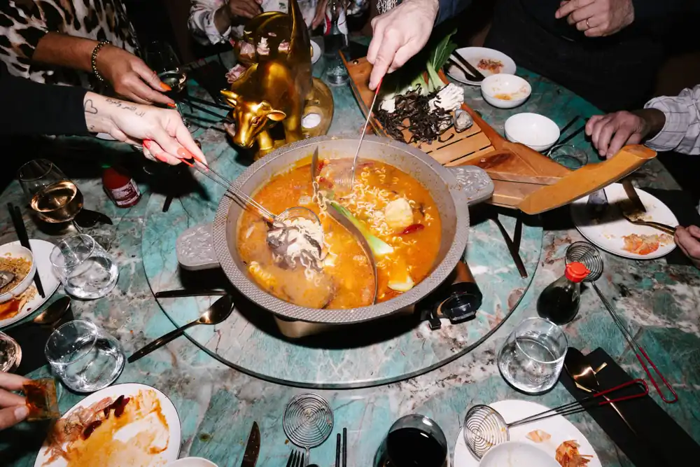 Gasten delen een dampende hot pot bij Restaurant Qin